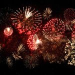 Photo: Stock image of red and yellow fireworks in a dark sky